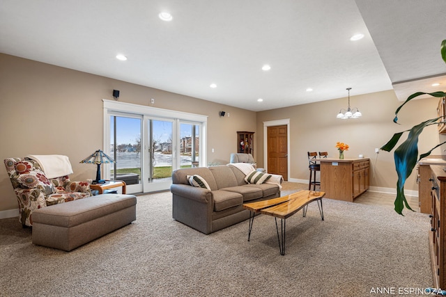 living area with recessed lighting, light colored carpet, and baseboards