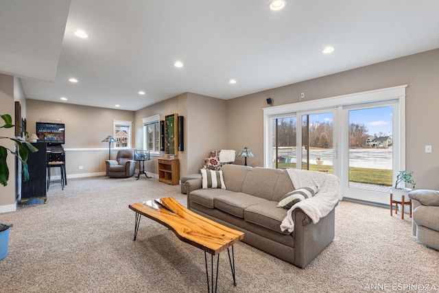 carpeted living area featuring recessed lighting and baseboards