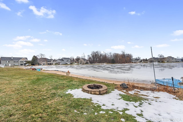 view of yard featuring a fire pit and a residential view