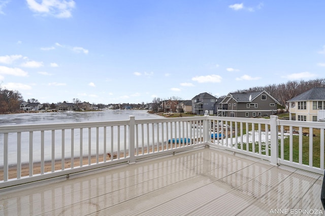 wooden deck featuring a water view and a residential view