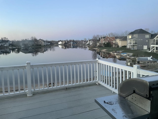 deck featuring a water view, a grill, and a residential view