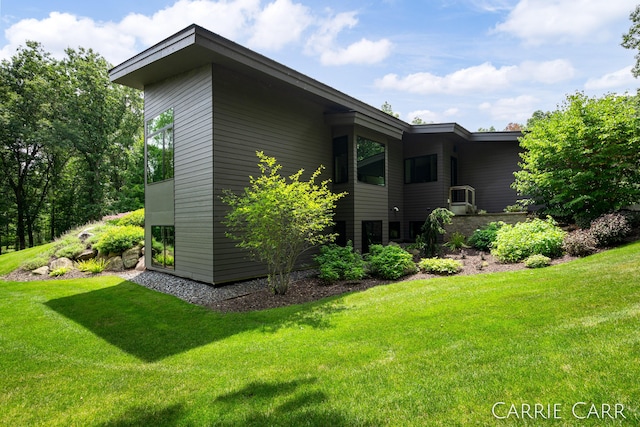 view of property exterior with a lawn