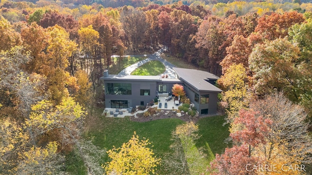 birds eye view of property with a wooded view