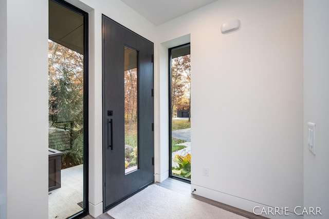 doorway to outside with a healthy amount of sunlight and wood finished floors