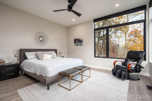 bedroom featuring a ceiling fan, recessed lighting, baseboards, and wood finished floors