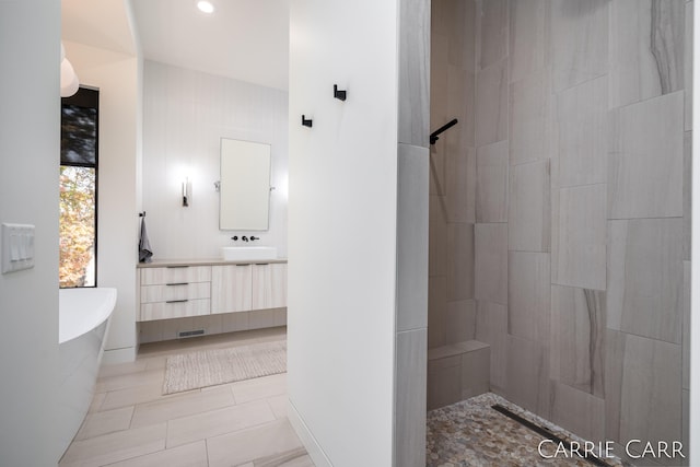 bathroom with tiled shower, a soaking tub, tile patterned flooring, vanity, and recessed lighting