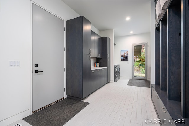 interior space with washing machine and dryer, recessed lighting, light wood-style floors, light countertops, and modern cabinets