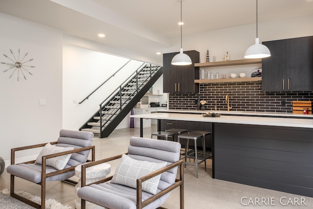 living room featuring recessed lighting and stairs