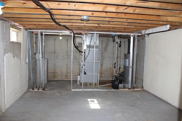 below grade area featuring washer / dryer, water heater, and heating unit