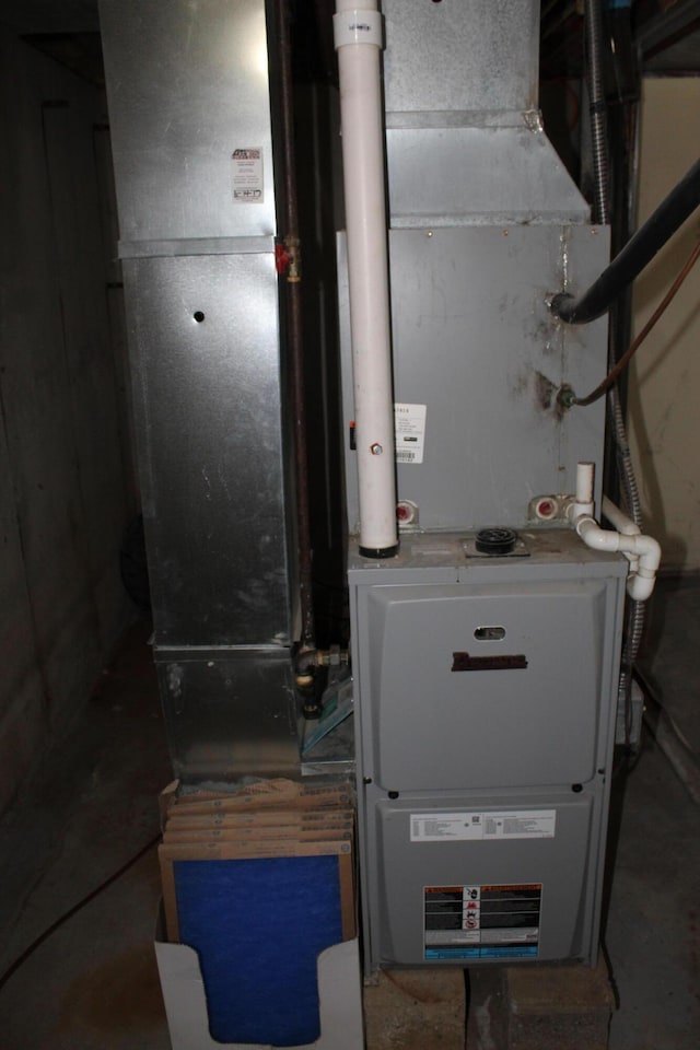 utility room featuring heating unit