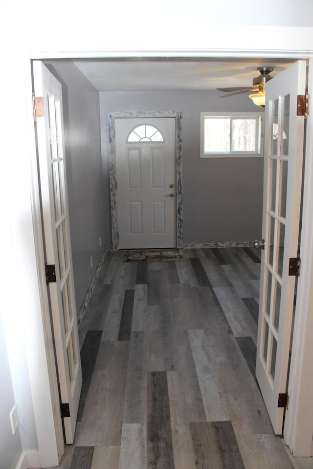 foyer with a ceiling fan, wood finished floors, and french doors