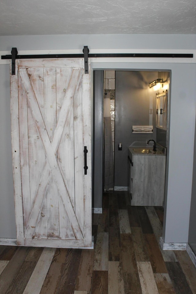 bathroom featuring vanity, a textured ceiling, and wood finished floors