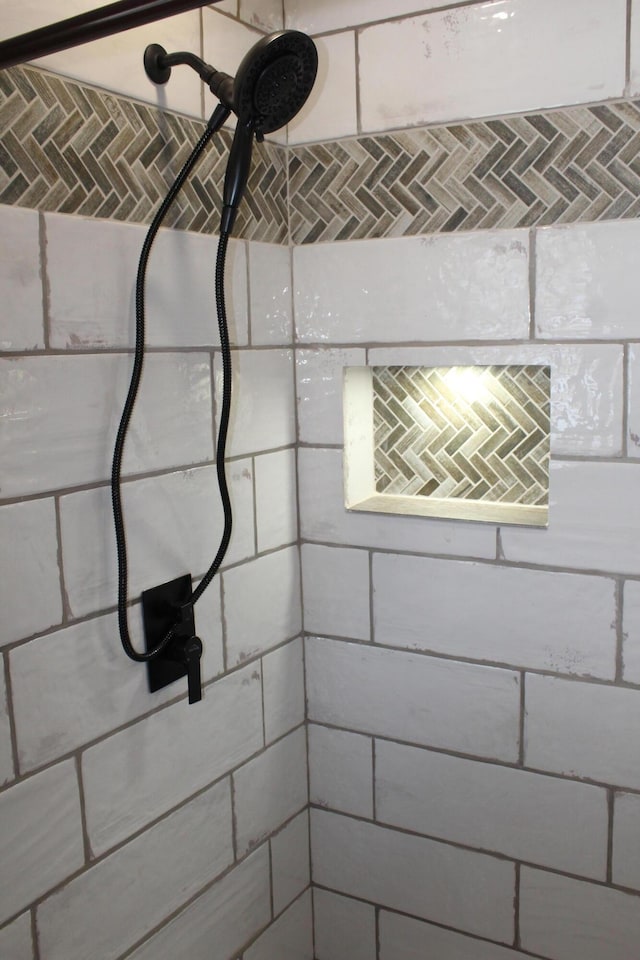 bathroom with tiled shower