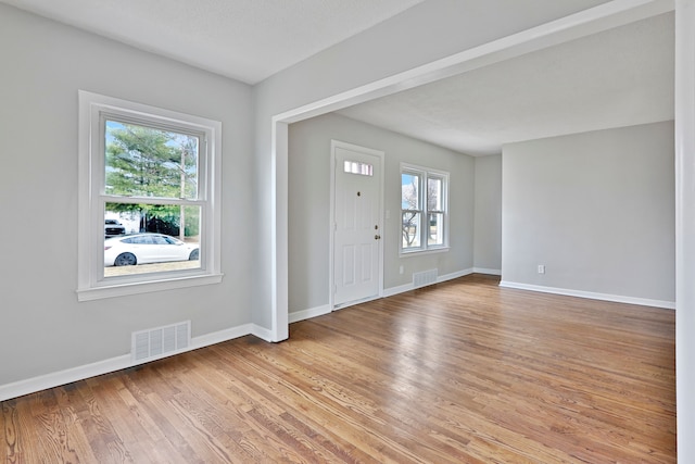 entryway with light wood-type flooring, baseboards, and visible vents