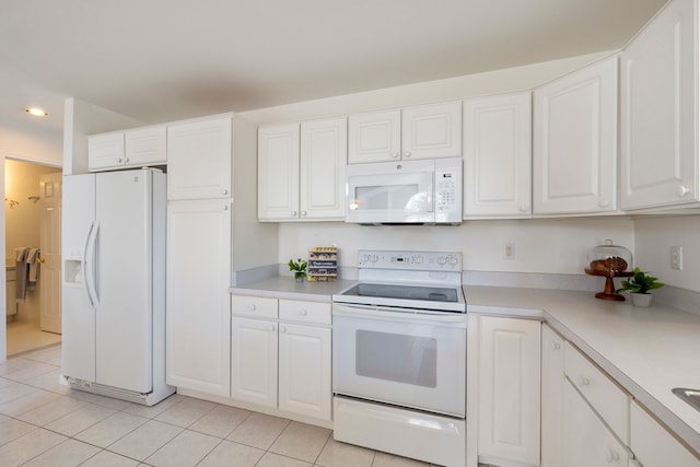 kitchen featuring white appliances, white cabinetry, and light countertops