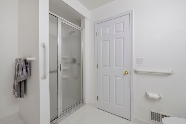 full bath with a shower stall and visible vents