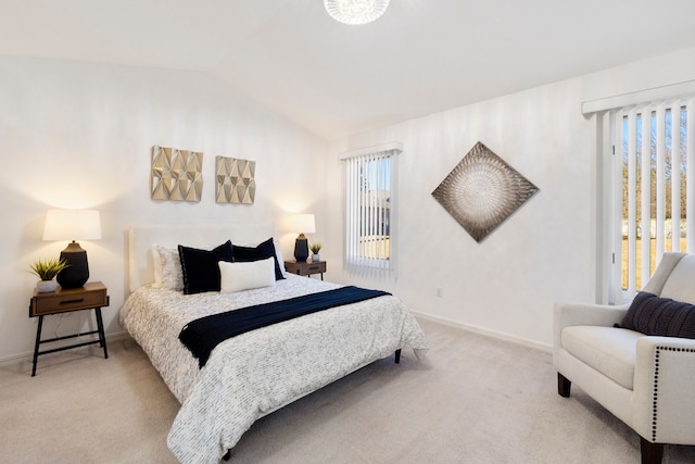 carpeted bedroom with vaulted ceiling and baseboards