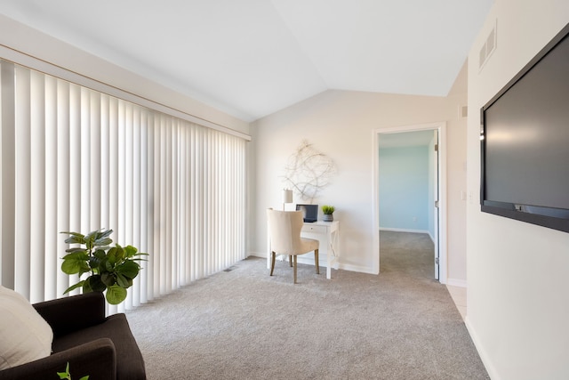 carpeted office featuring visible vents, baseboards, and lofted ceiling