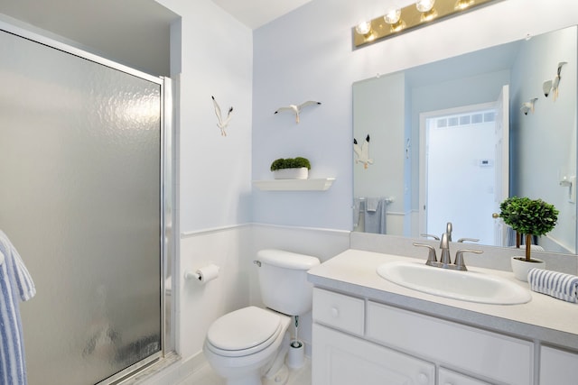 full bath featuring vanity, a shower stall, and toilet