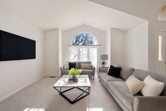 living room with light carpet, baseboards, and vaulted ceiling