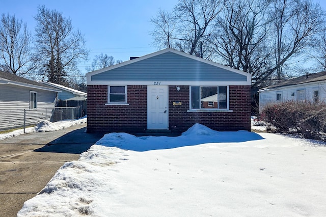 bungalow with brick siding and fence