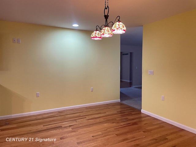 unfurnished room with baseboards, light wood finished floors, and recessed lighting