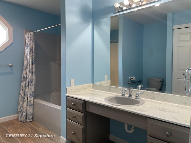 full bathroom with shower / bath combo, toilet, baseboards, wood finished floors, and vanity