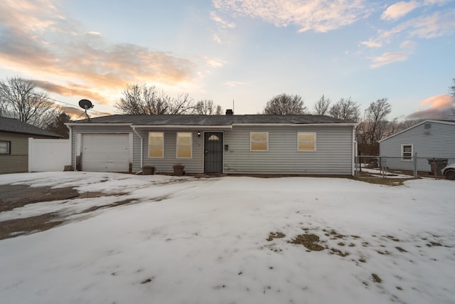 ranch-style house with fence and an attached garage