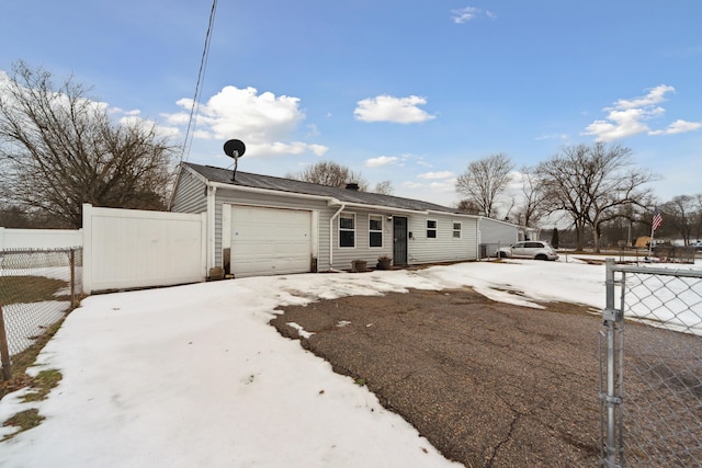 view of front of house featuring an attached garage, driveway, and fence