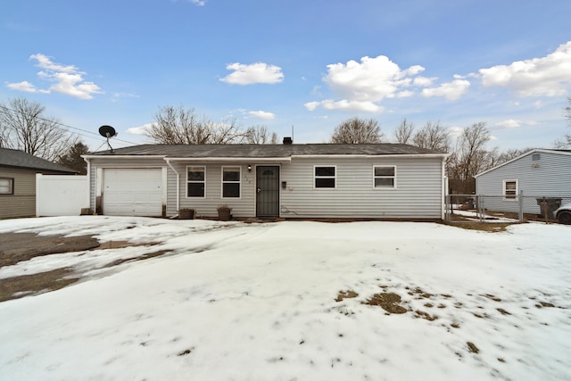 ranch-style home with a garage and fence