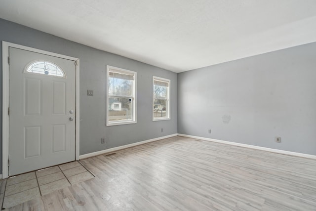 entrance foyer with visible vents, baseboards, and wood finished floors