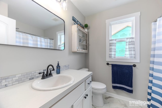 full bath with marble finish floor, curtained shower, toilet, vanity, and baseboards