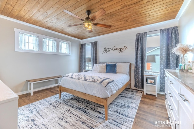 bedroom with wooden ceiling, baseboards, crown molding, and light wood finished floors