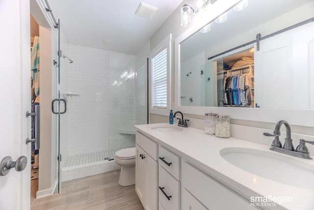 full bath with a stall shower, a sink, and toilet