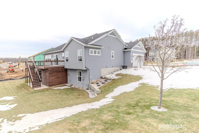 view of side of home featuring a yard, driveway, a deck, and stairs