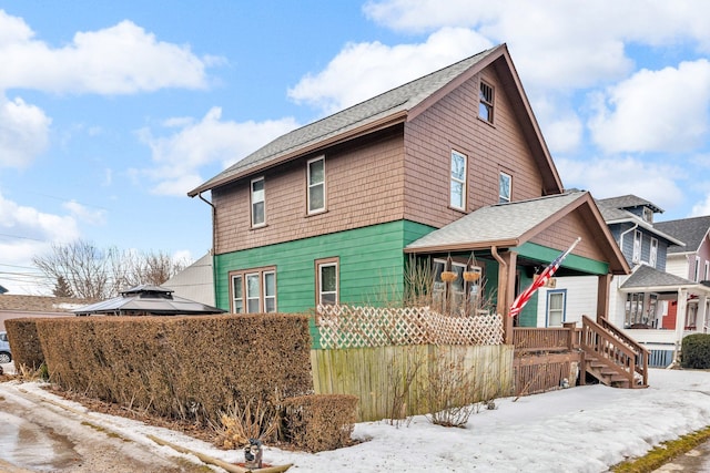 exterior space featuring roof with shingles