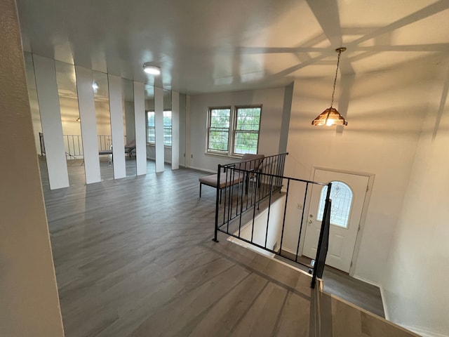 foyer entrance with wood finished floors and baseboards