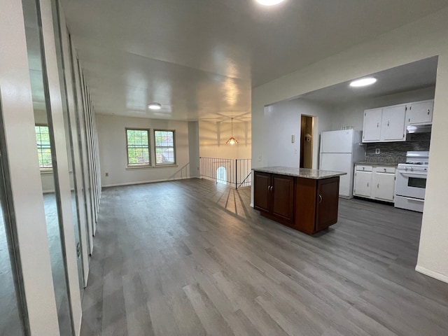 kitchen featuring backsplash, white cabinets, wood finished floors, white appliances, and under cabinet range hood