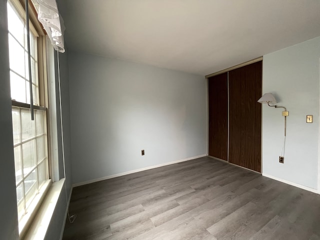 empty room featuring baseboards and wood finished floors