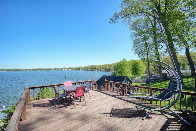 wooden terrace featuring a water view