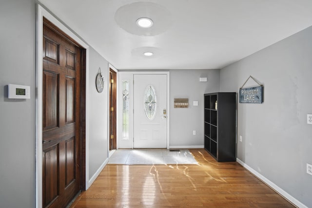 entrance foyer featuring light wood-style floors and baseboards