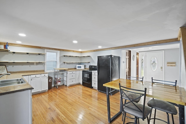 kitchen with light wood-style flooring, recessed lighting, open shelves, a sink, and black appliances