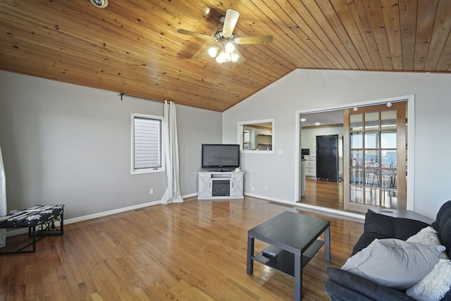 living area with lofted ceiling, a ceiling fan, wood finished floors, wooden ceiling, and baseboards