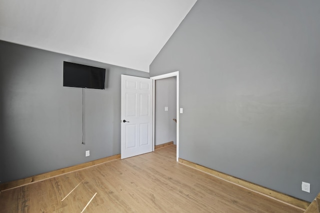 interior space with high vaulted ceiling and wood finished floors