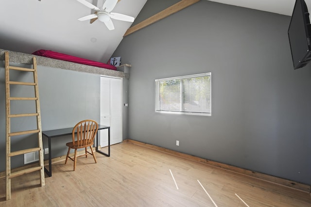 home office with high vaulted ceiling, visible vents, ceiling fan, and wood finished floors