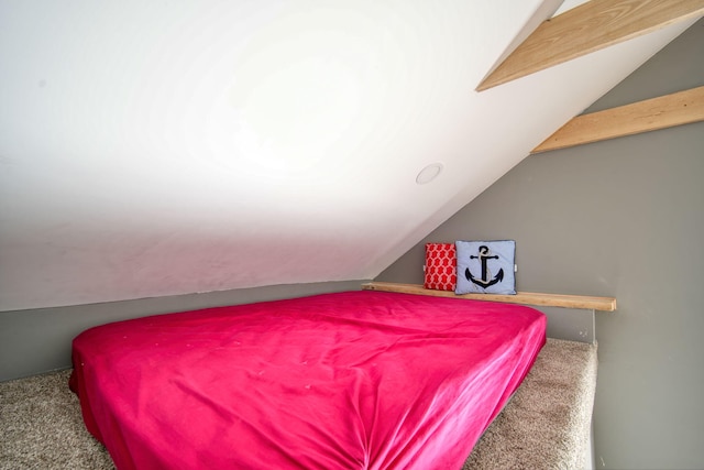 bedroom with lofted ceiling and carpet floors