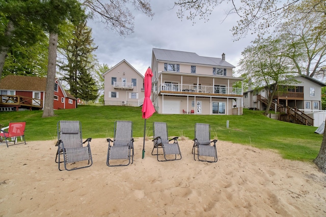 back of property with a lawn and a wooden deck