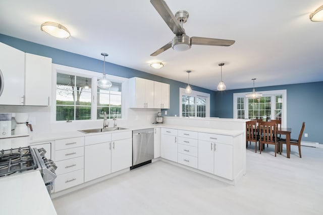 kitchen featuring light countertops, appliances with stainless steel finishes, a sink, and white cabinetry