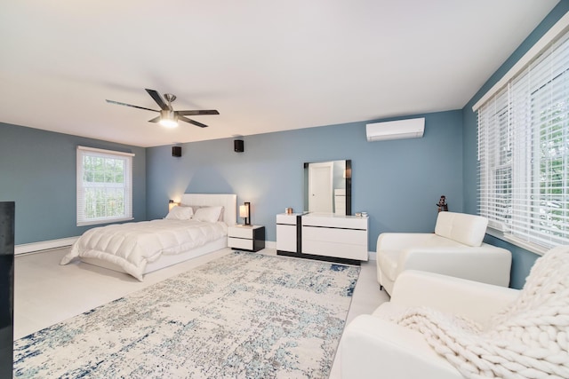 bedroom with a wall mounted AC, baseboard heating, a ceiling fan, and baseboards