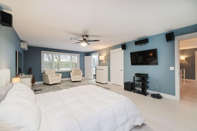 bedroom with ceiling fan, baseboards, and an AC wall unit